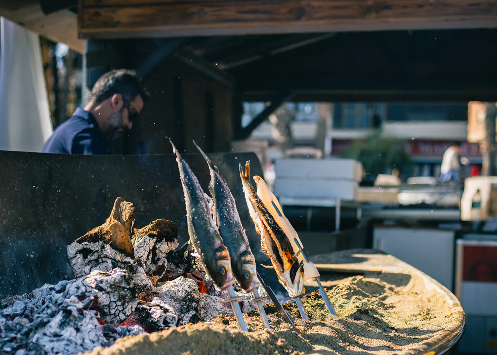 Traditional espetos roasting over an open fire, a distinctive taste of life beside the sea in Málaga.